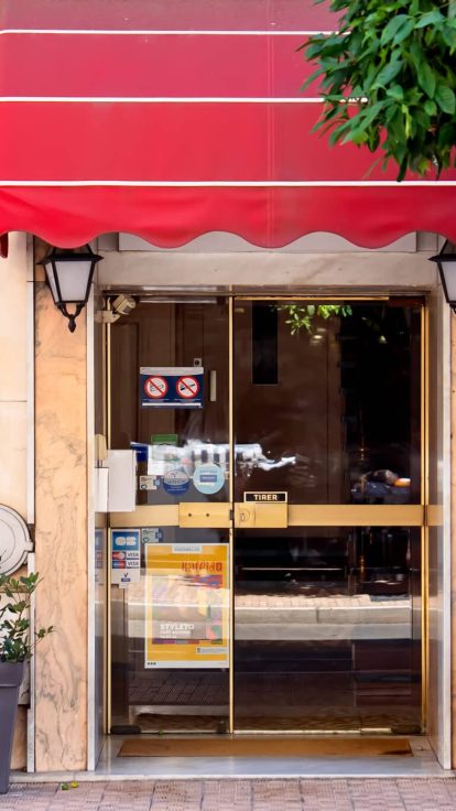 Facade and entrance of Hotel Louvia in downtown Menton